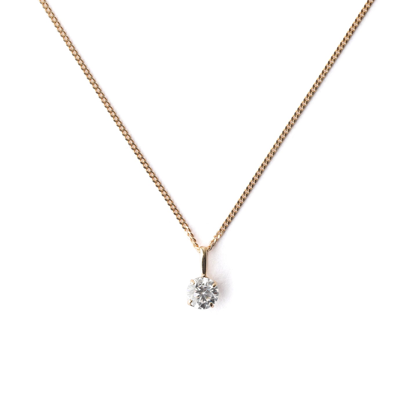 Women's 9K solid yellow gold necklace with a small cubiz zirconia pendant on a white background
