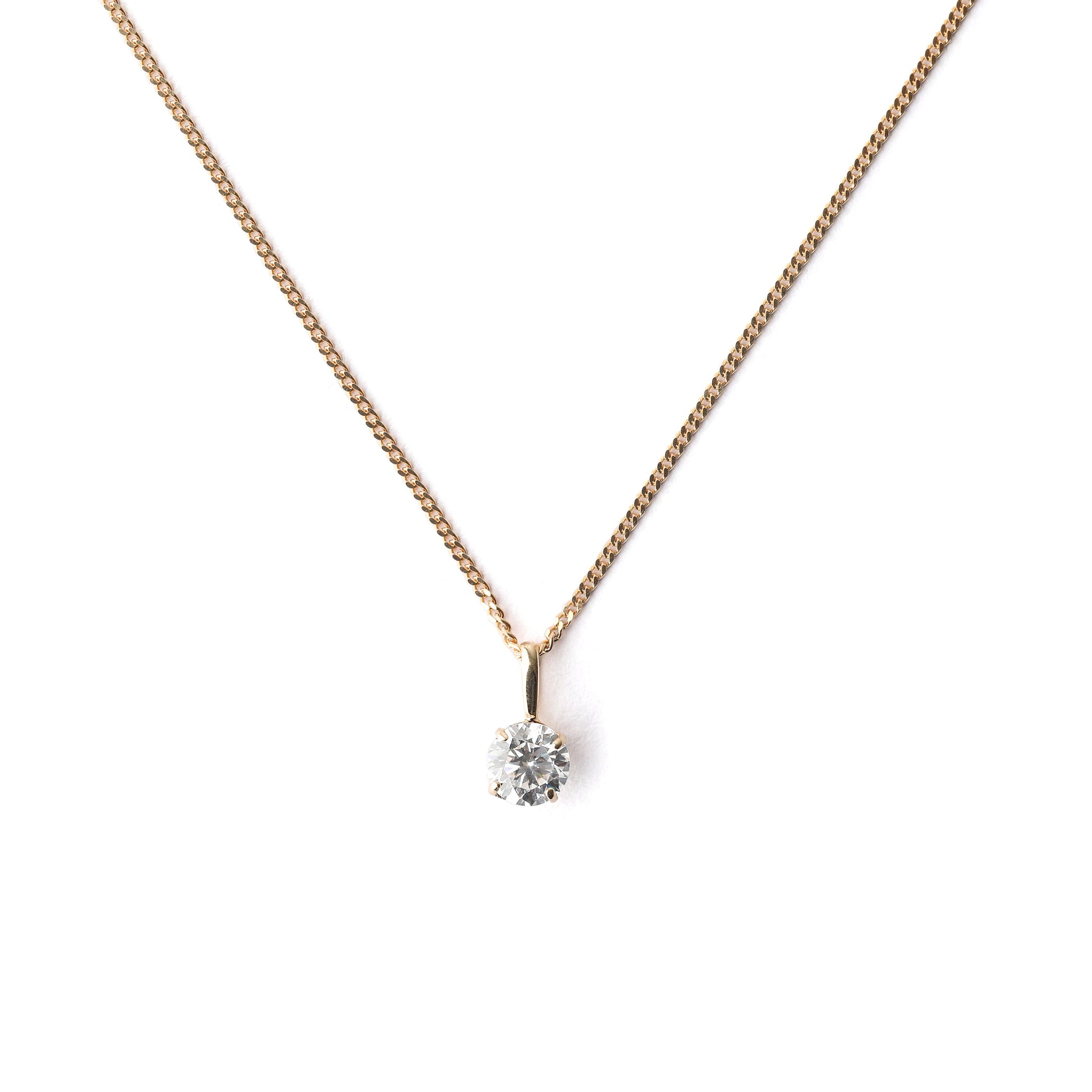 Women's 9K solid yellow gold necklace with a small cubiz zirconia pendant on a white background