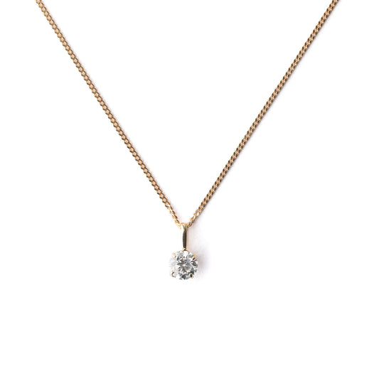 Women's 9K solid yellow gold necklace with a small cubiz zirconia pendant on a white background