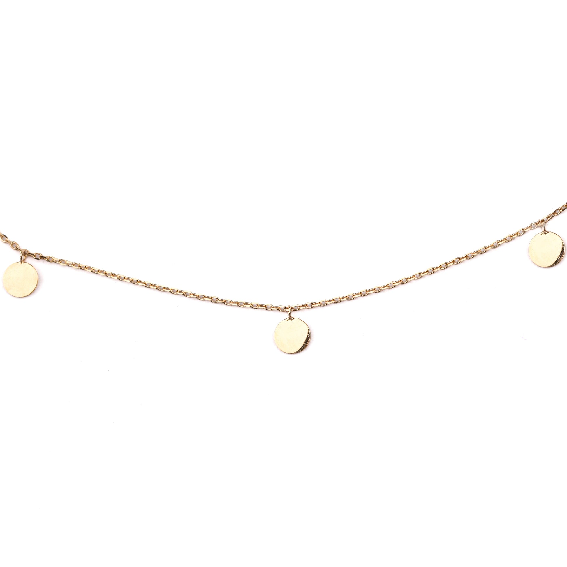 Women's solid gold necklace with three small round disks embelishing the chain on a white background