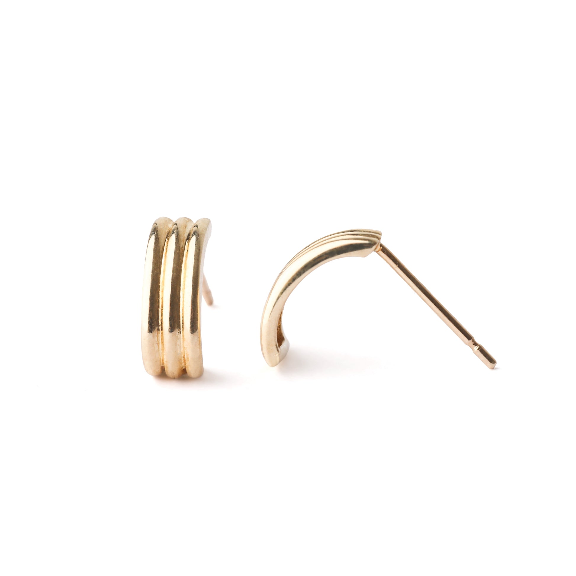 women's solid gold half hoop stud earrings on a white background