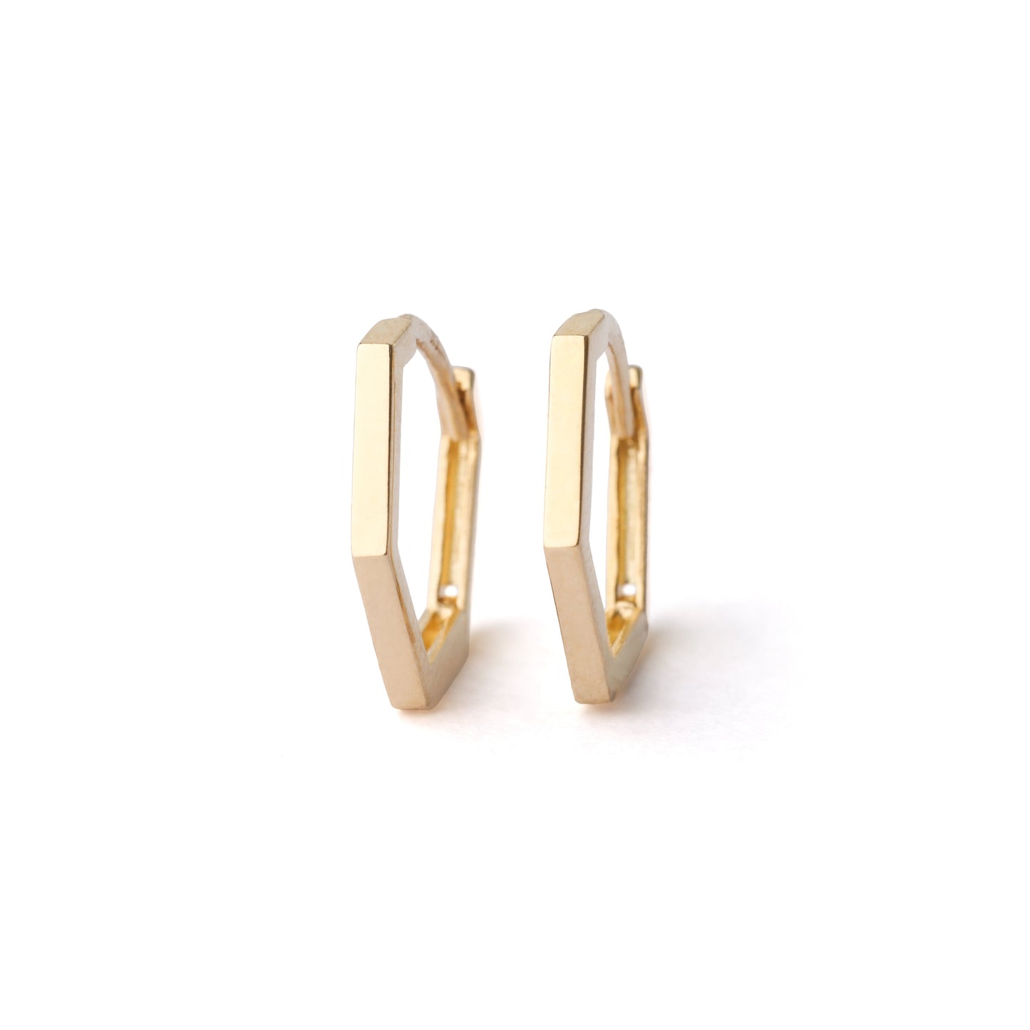 A pair of women's solid gold 13mm hexagonal hoop earrings on a white background