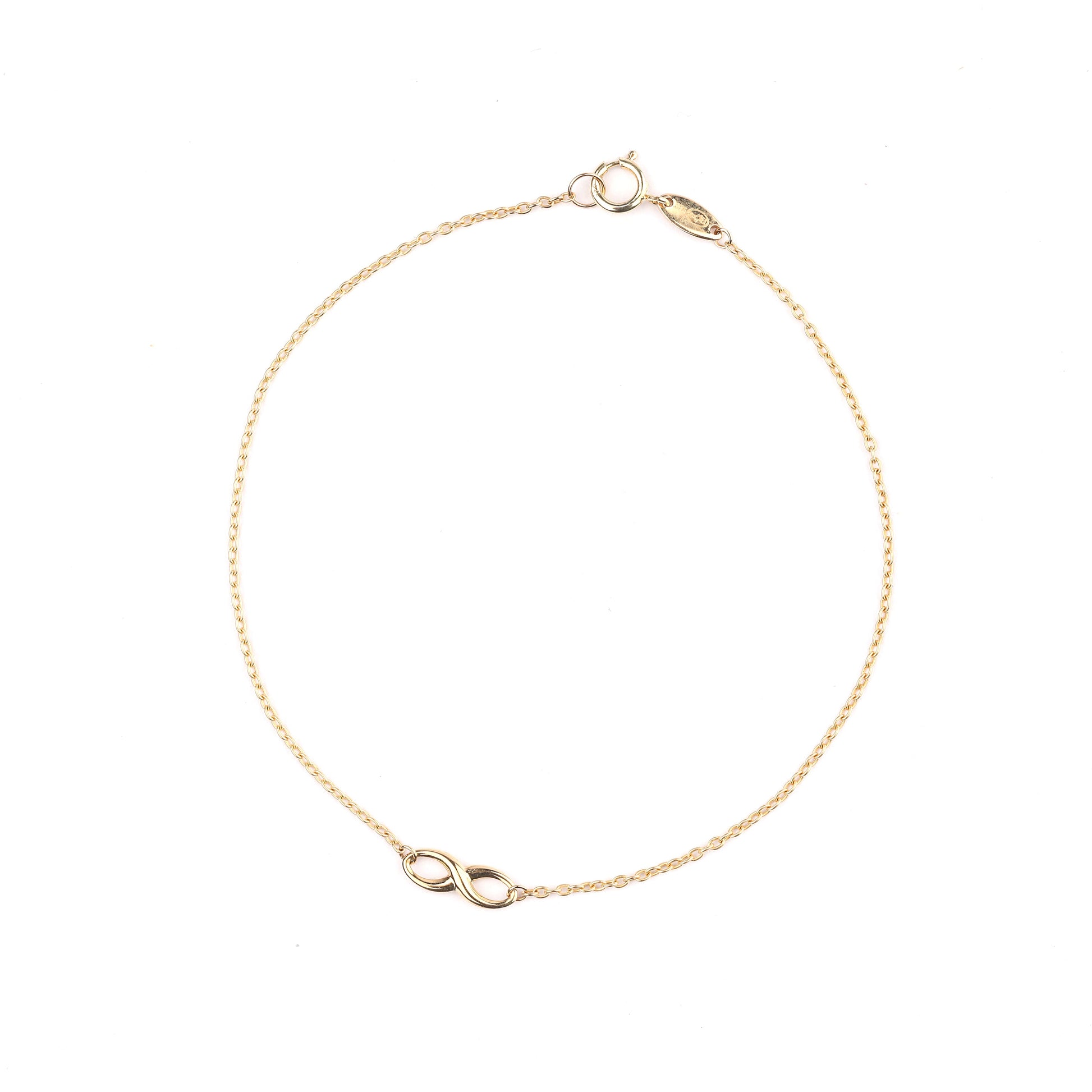 Women's 9K solid yellow gold infinity bracelet on a white background