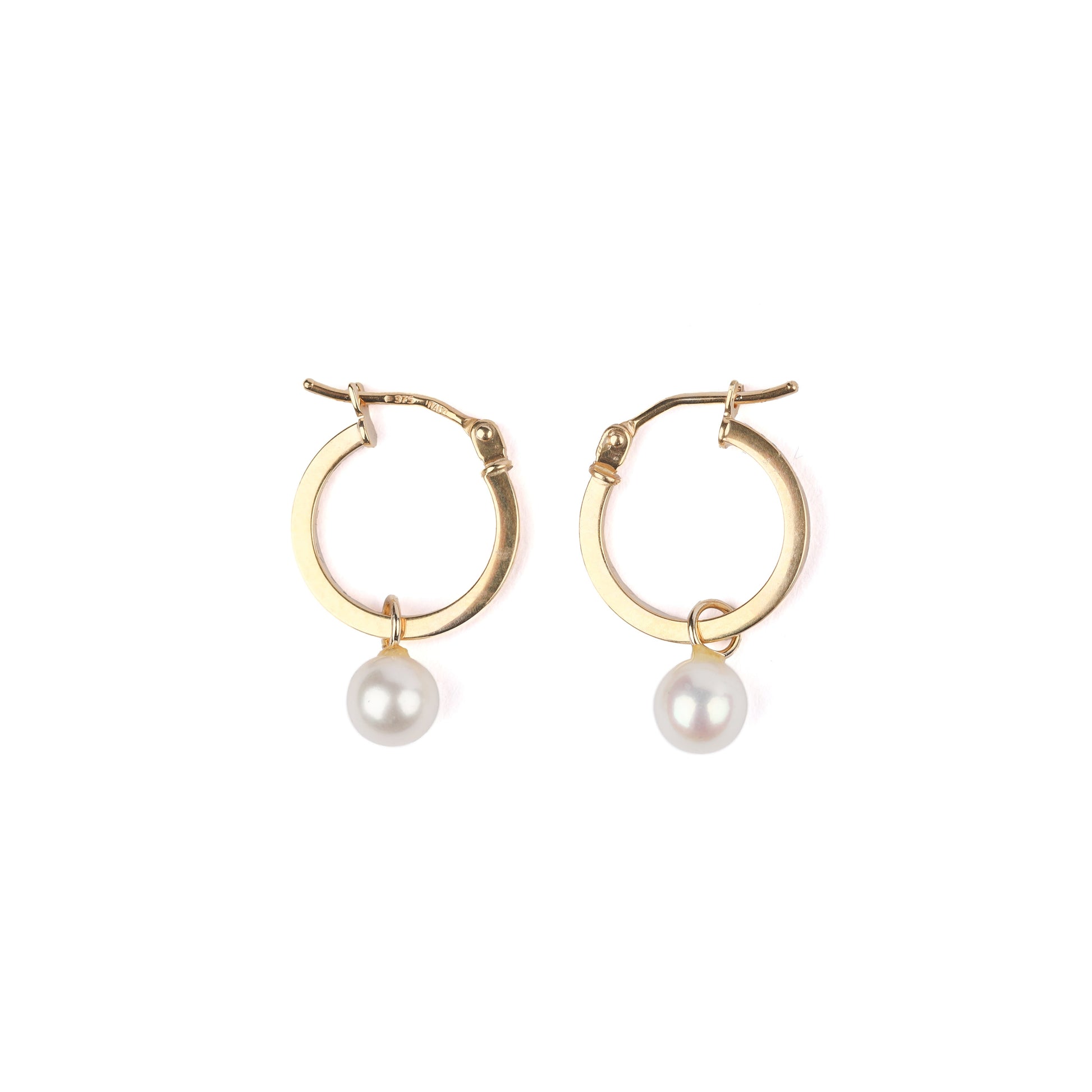 A pair of women's solid yellow gold hoop earrings with freshwater pearl drops on a white background