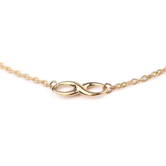 Women's 9K solid yellow gold bracelet with infinity symbol as part of the chain, on a white background