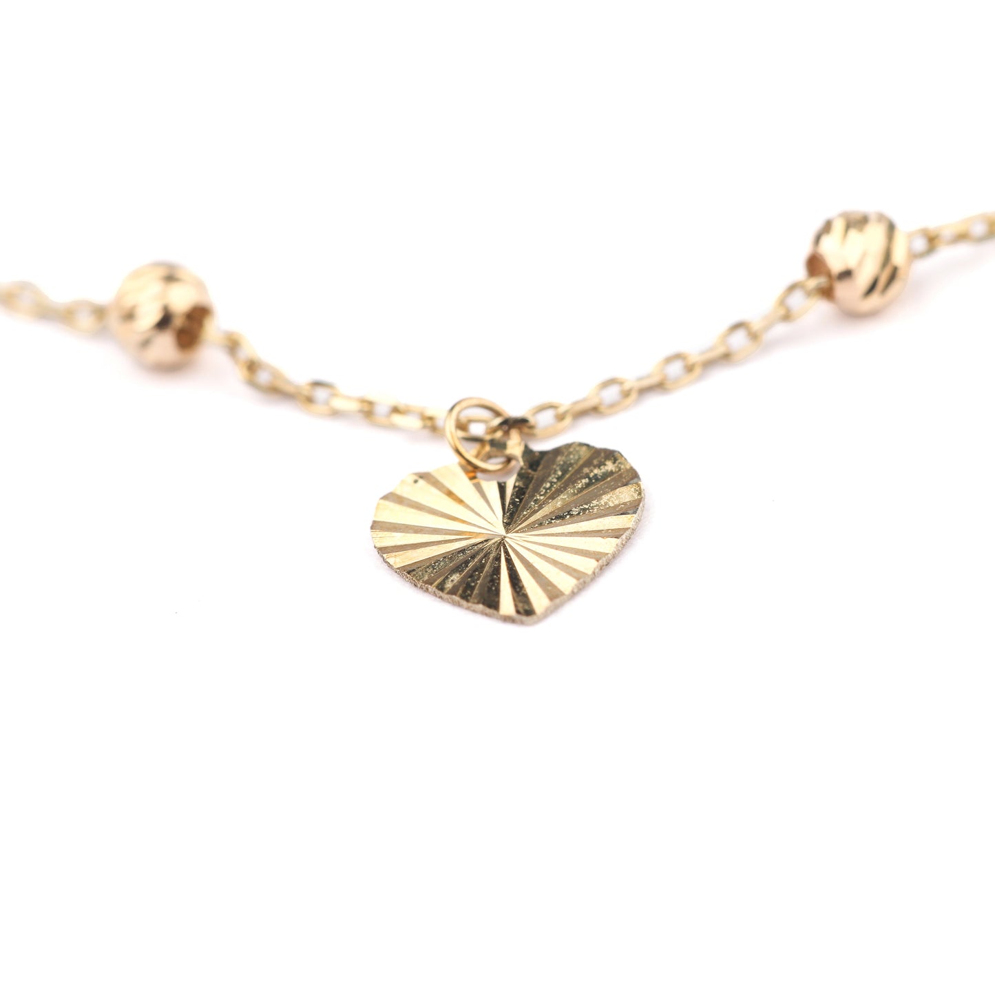 Women's 9K solid yellow gold brcelet with a detailed heart pendant on a white background