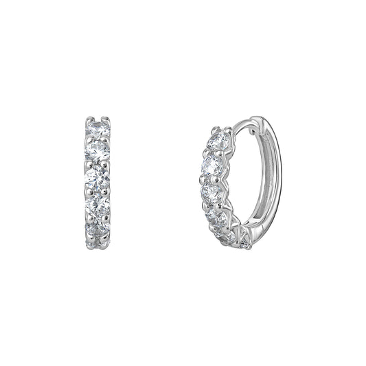 A pair of women's rhodium plated sterling silver huggie hoop earrings with cubic zirconia gemstones on a white background