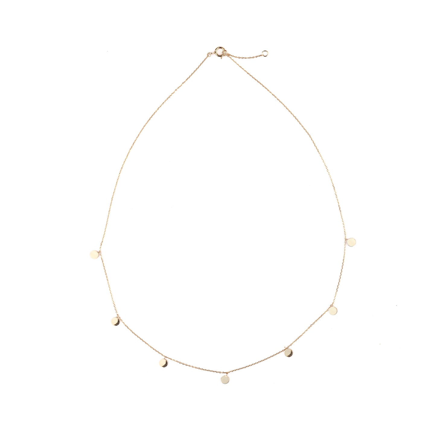 Delicate women's gold necklace with seven small discs on the chain set on a white background