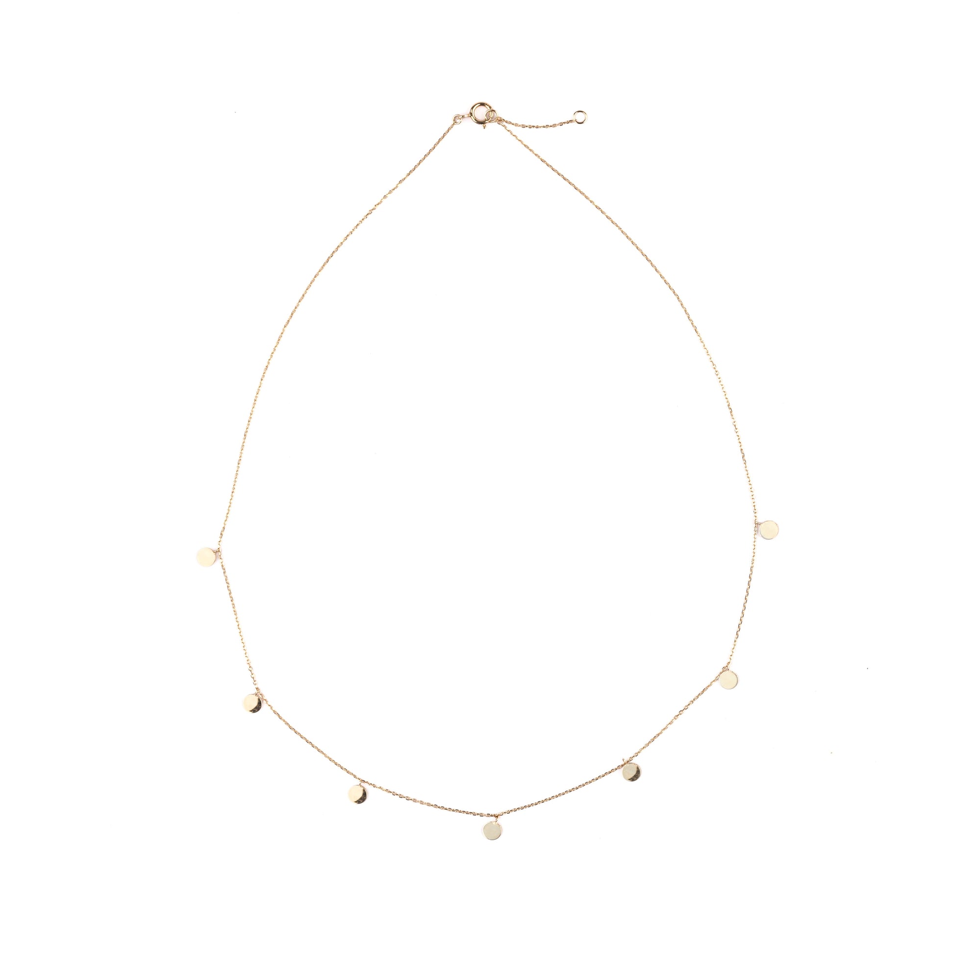 Delicate women's gold necklace with seven small discs on the chain set on a white background