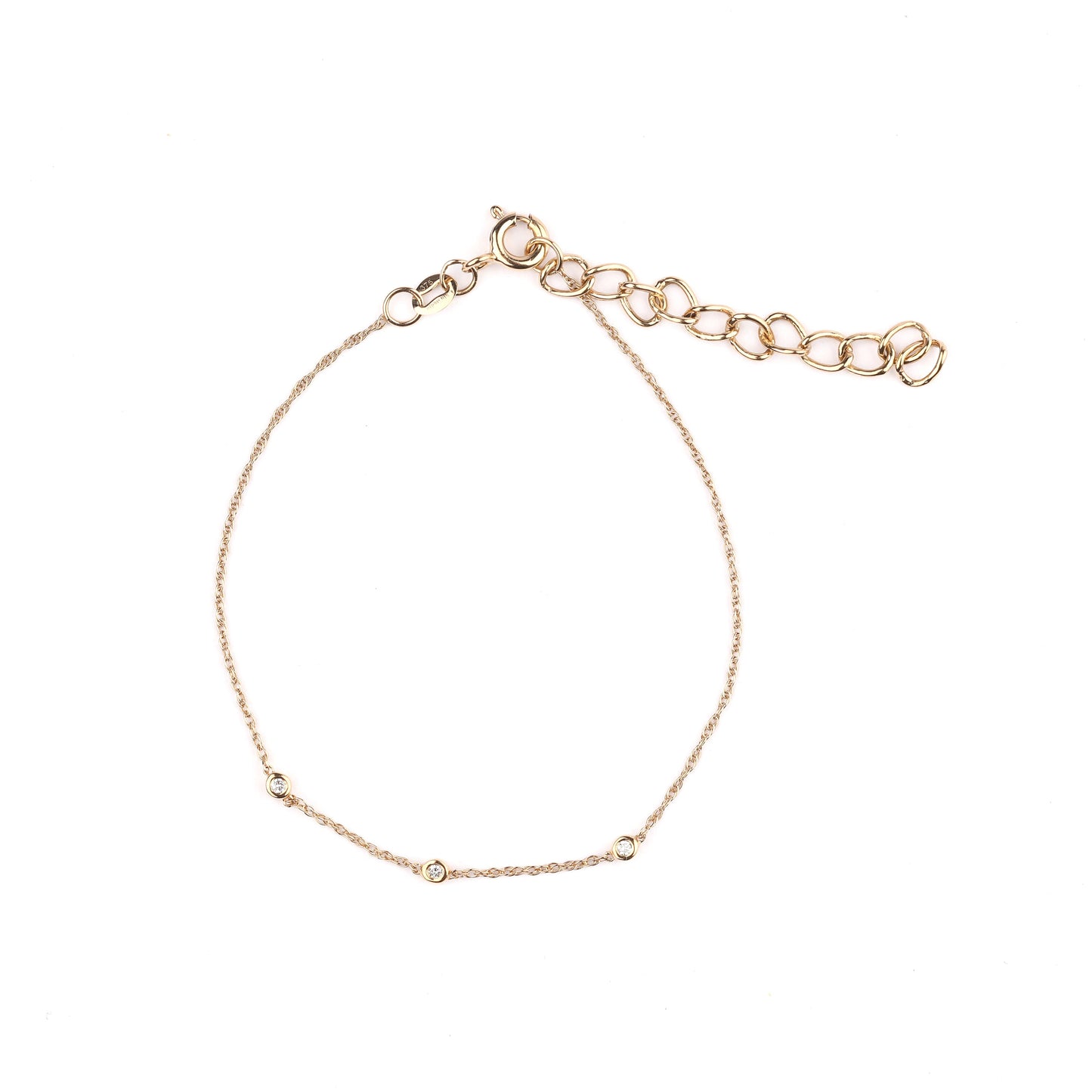 Women's solid gold and trio of bezel-set diamonds bracelet on a white background