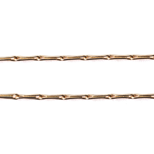 Women's solid gold hayseed chain necklace and bracelet on a white background