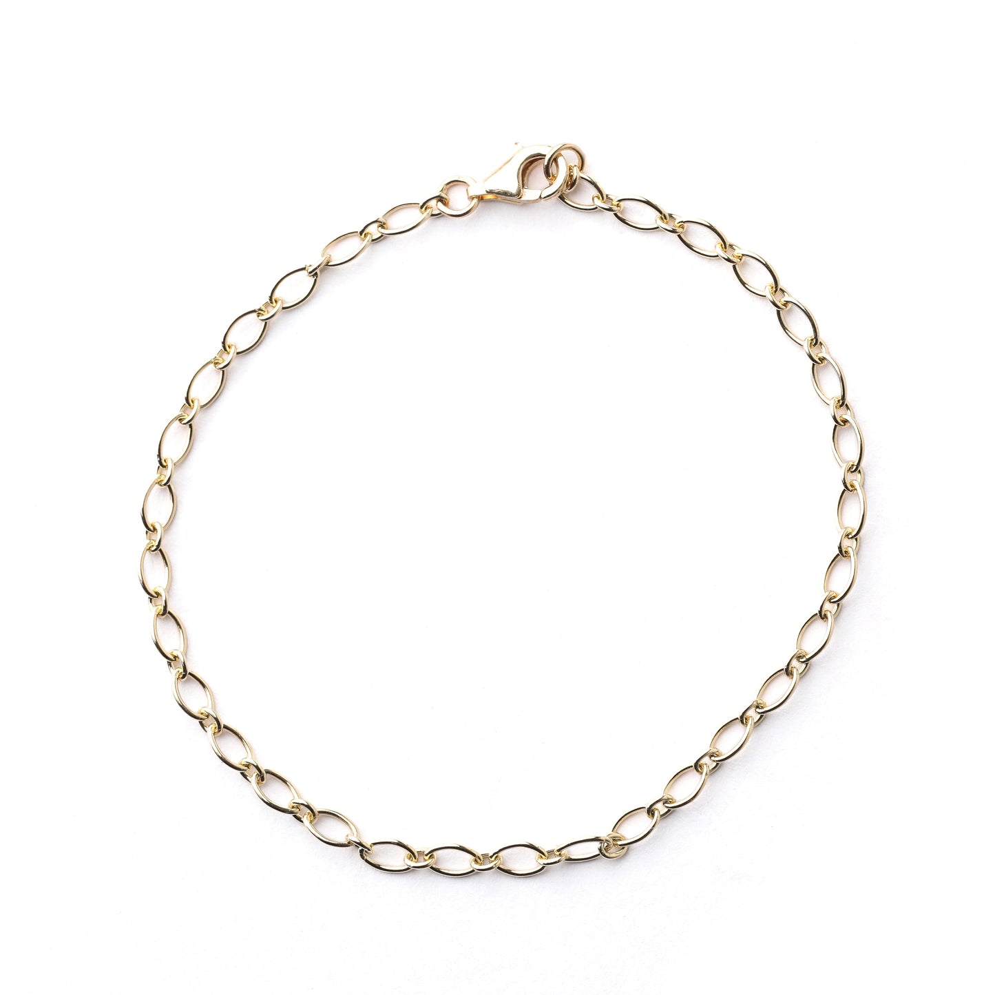 Women's solid gold trace chain bracelet on a white background