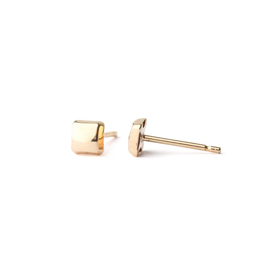 A pair of women's solid gold square stud earrings on a white background