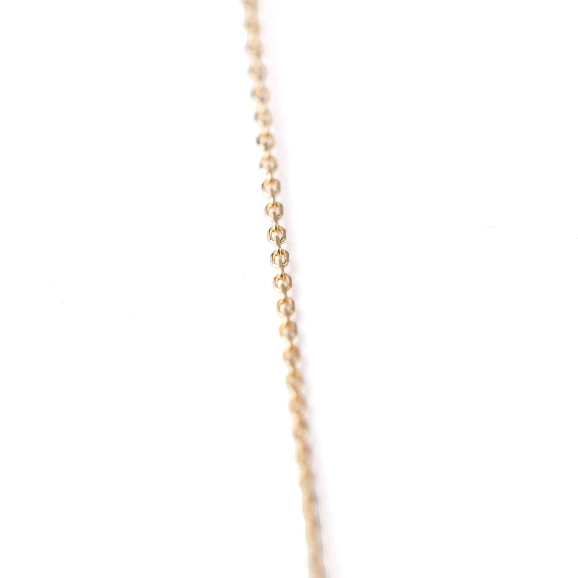 Women's 10K solid yellow gold thin link chain bracelet on a white background