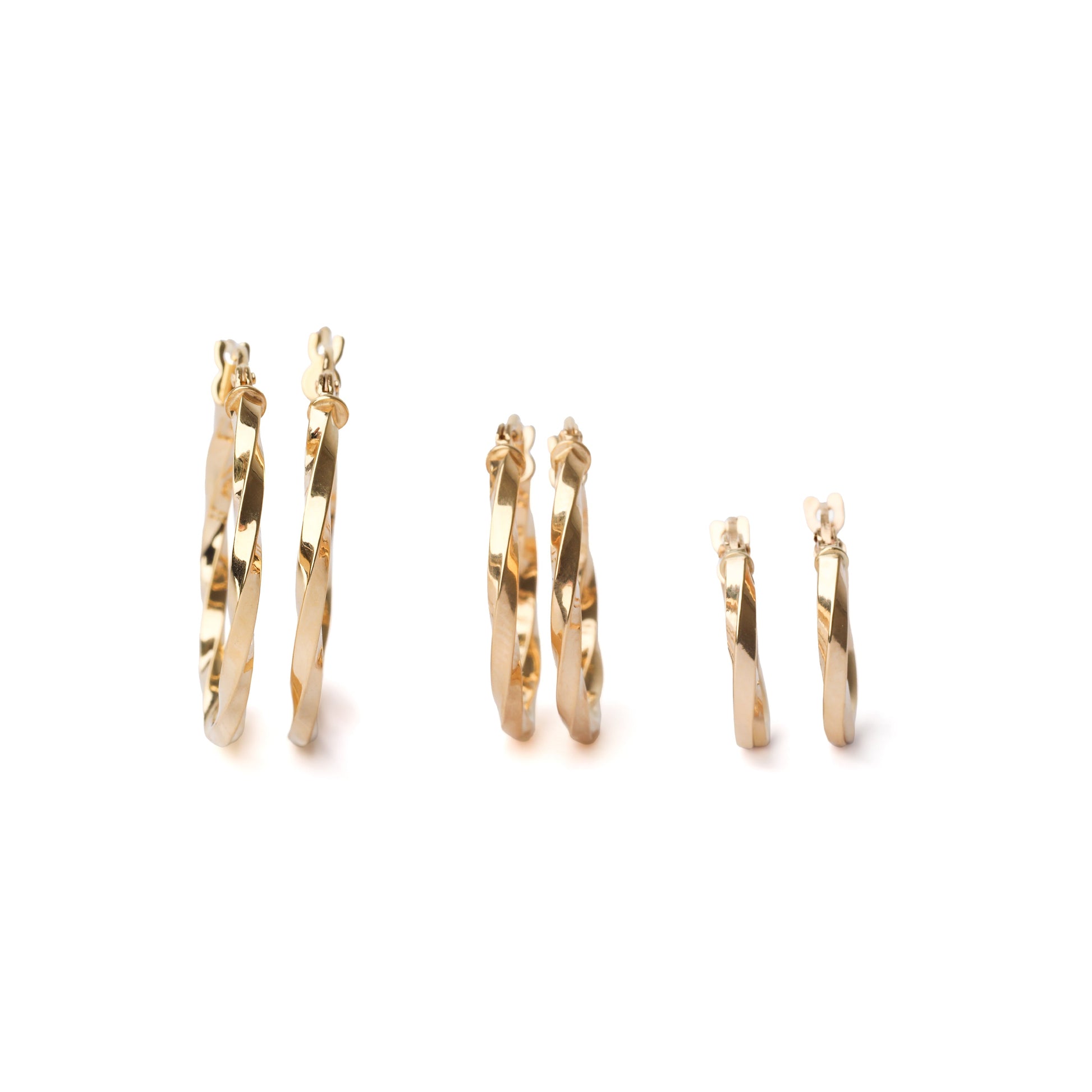Three pairs of women's solid gold twisted hoop earrings on a white background in small 10mm, medium 15mm and large 20mm