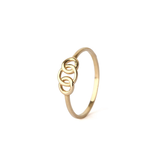 Women's solid yellow gold ring with a decorative design of three intertwined circles, displayed on a white background
