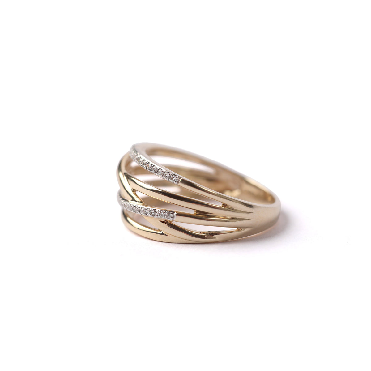 Women's solid yellow gold ring with 5 connected bands, with two of the bands set with diamonds, displayed on it's side on a white background.