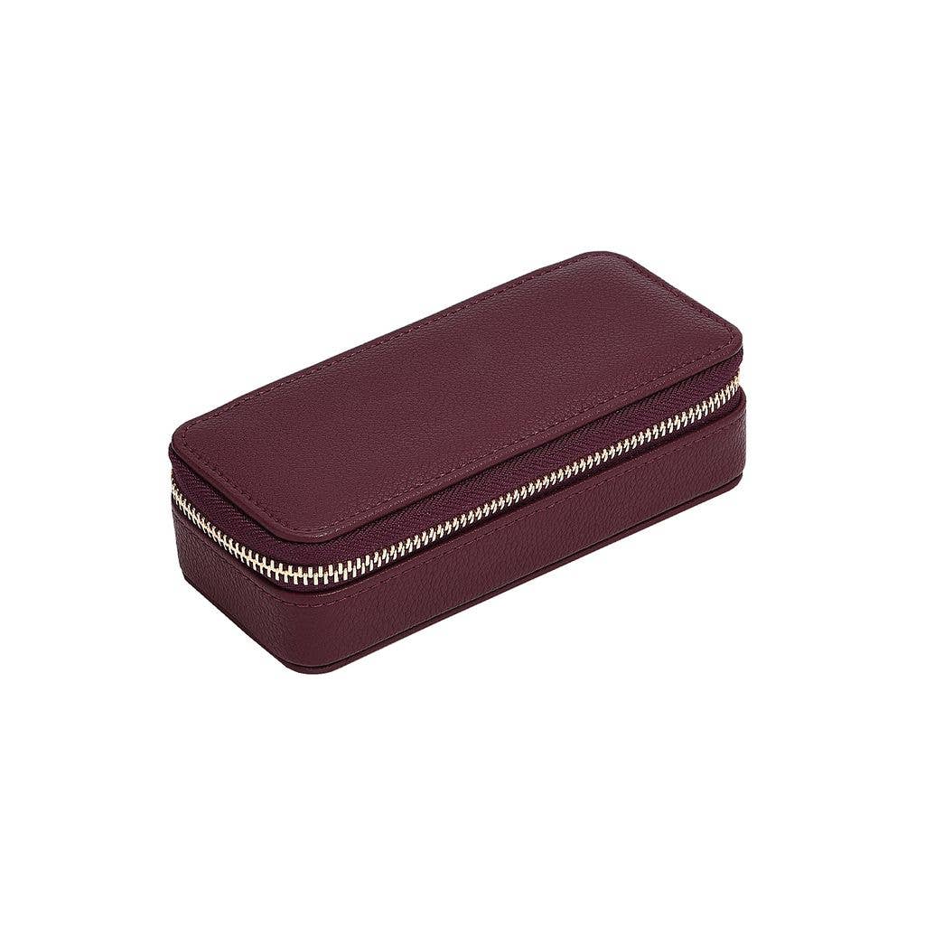 Medium burgundy travel jewellery case from Stackers, zipped up and on a white background.