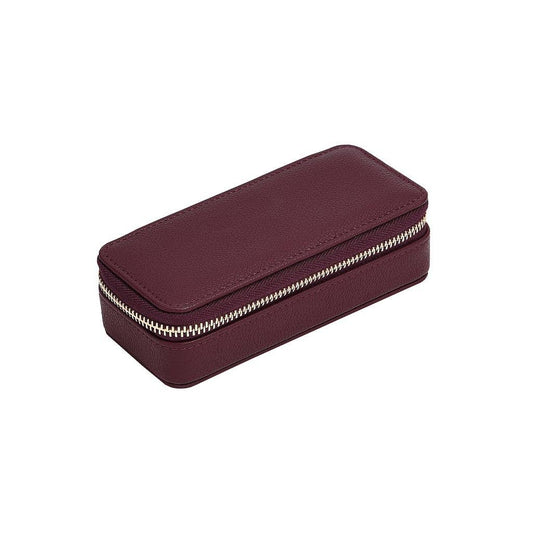 Medium burgundy travel jewellery case from Stackers, zipped up and on a white background.