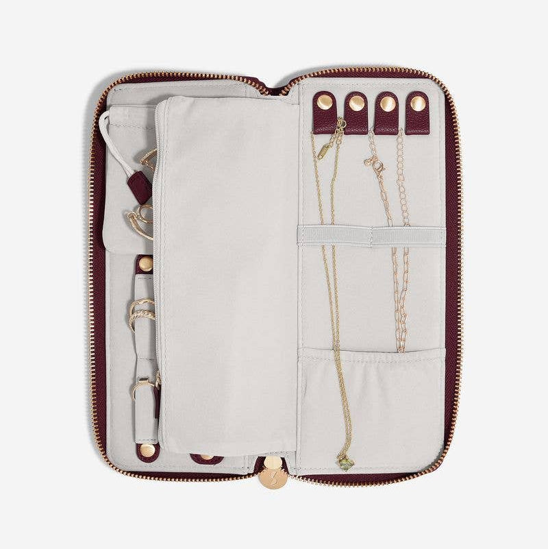 Large burgundy Stackers travel jewellery roll on a white background with various internal compartments