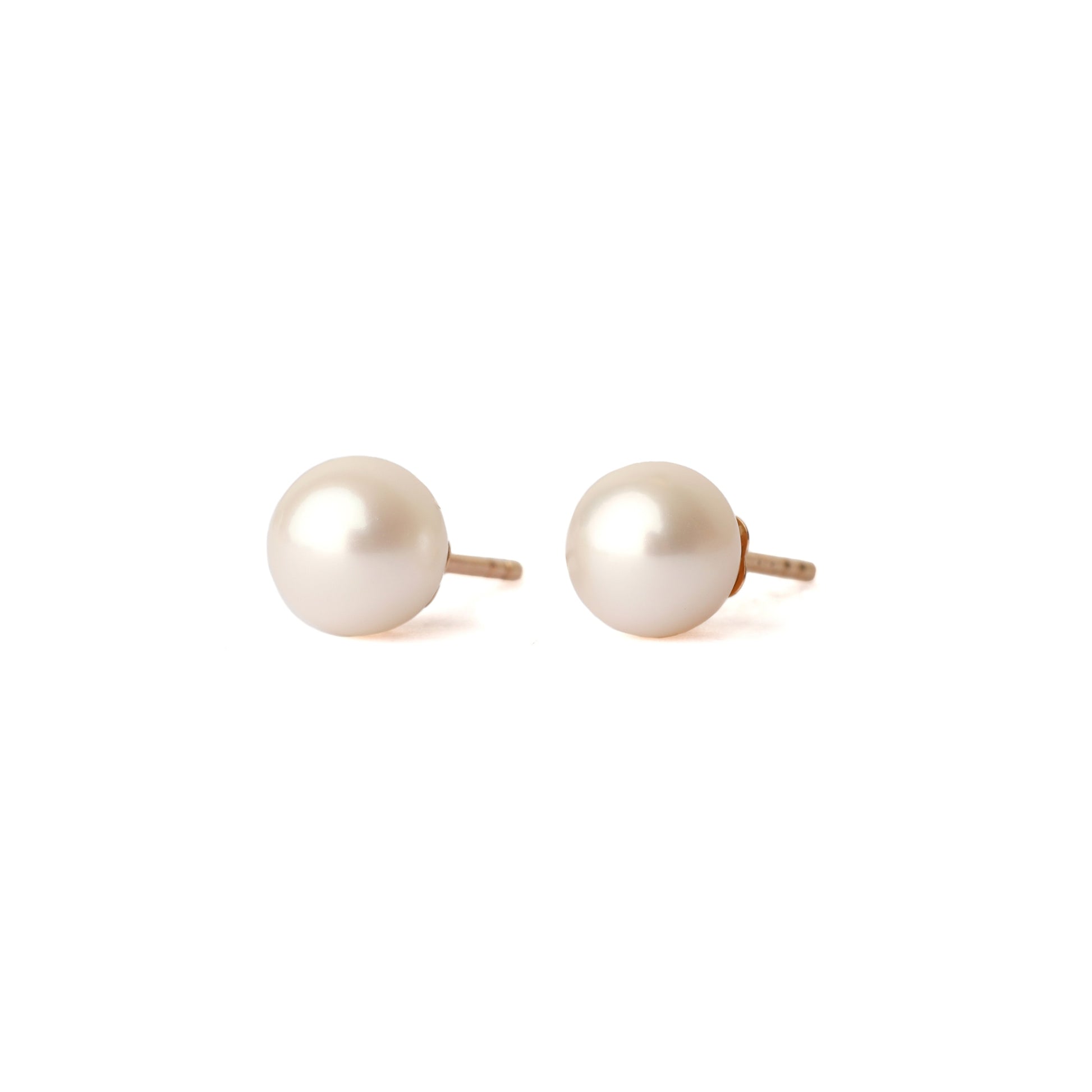 A pair of solid yellow gold and freshwater pearl earrings, classic size. Both face forward and are set on a white background for the shopper to view.