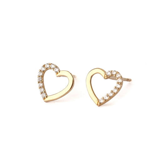 A pair of solid yellow gold heart shape earrings with an open centre. each earring has small cubic zirconia gemstones set into one side of the heart outline. The pair faces frontwards and both are displayed on a white background for the shopper to see.