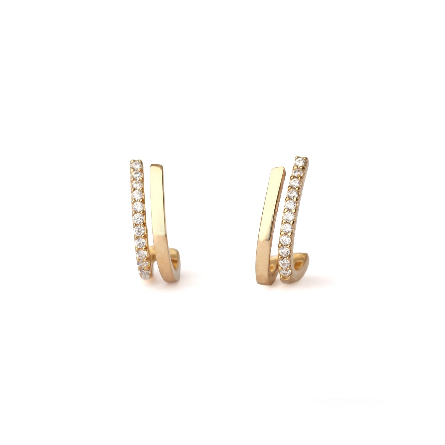 A pair of solid yellow gold half hoop earrings set with cubic zirconia along one edge. The earrings are facing forward and both are on a white background for the shopper to view.