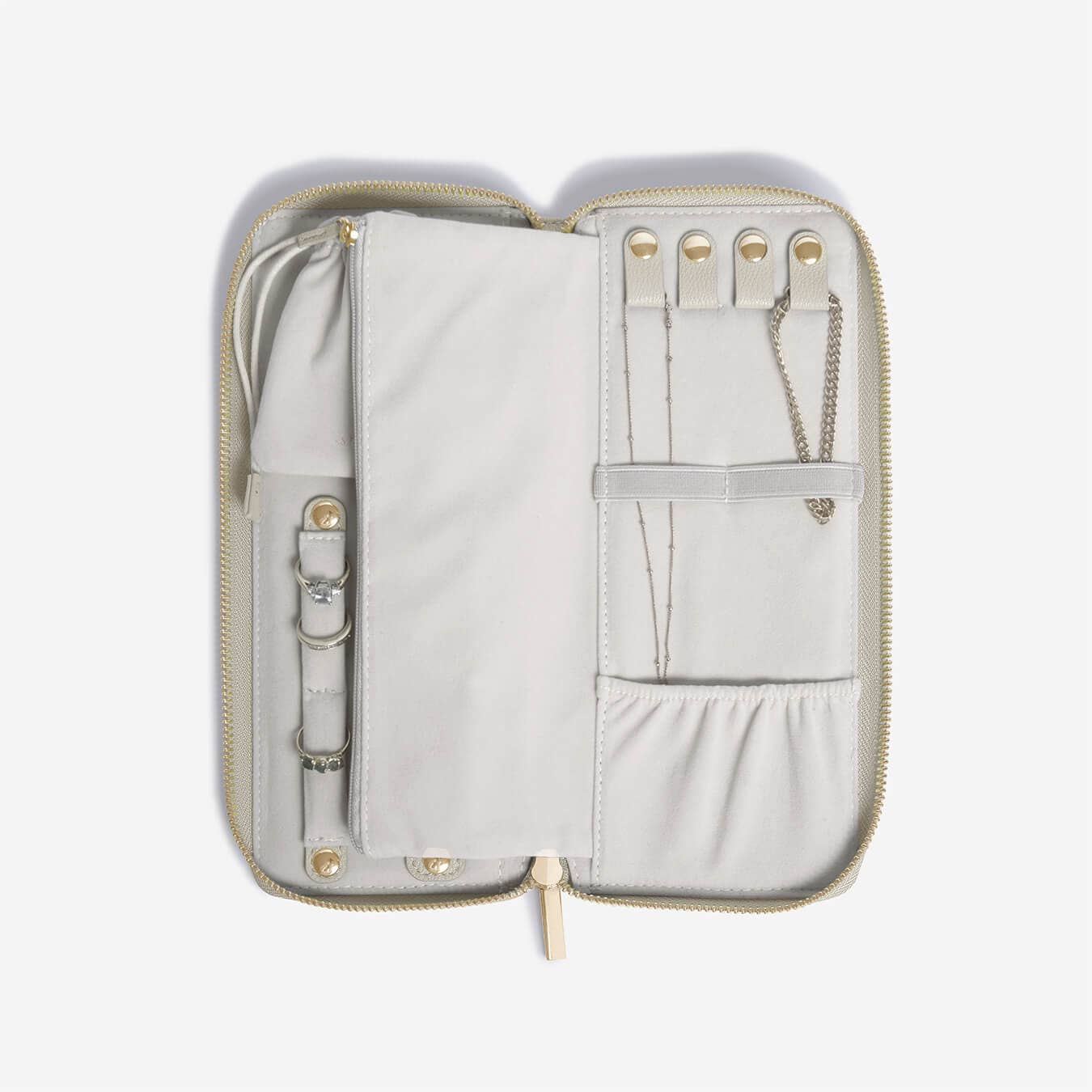 Light gray travel organizer with gold zippers on a white background