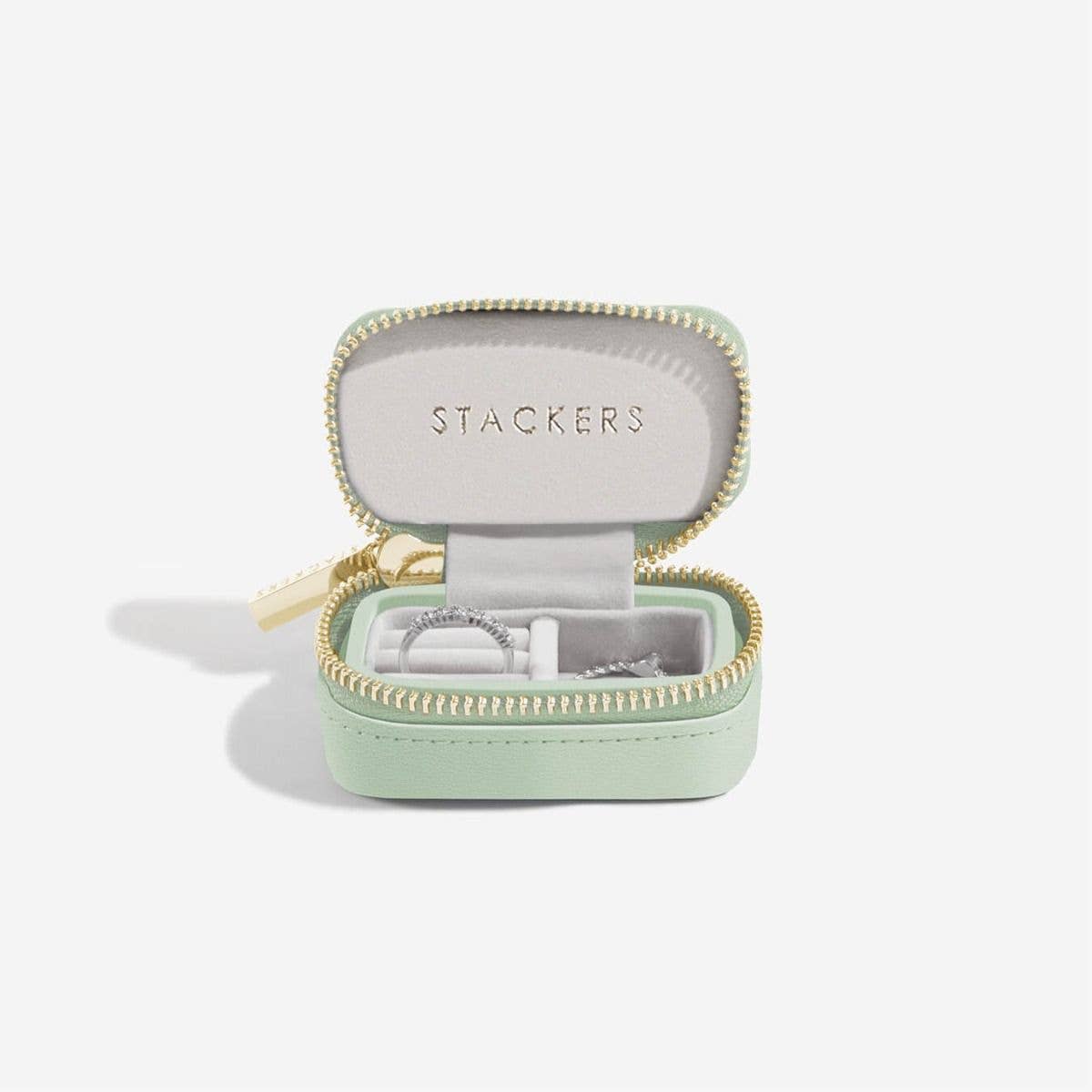 Mini mint green travel jewellery case with gold zipper and 'Stackers' branding on a white background