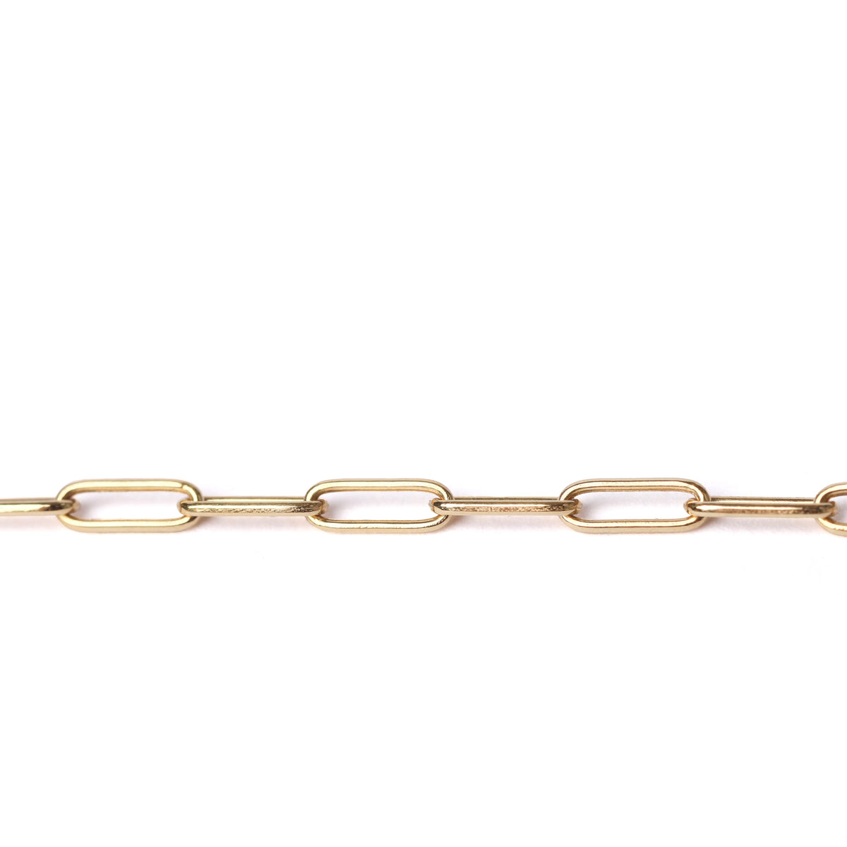 A close-up of a gold paperclip chain running horizontally across a plain white background.