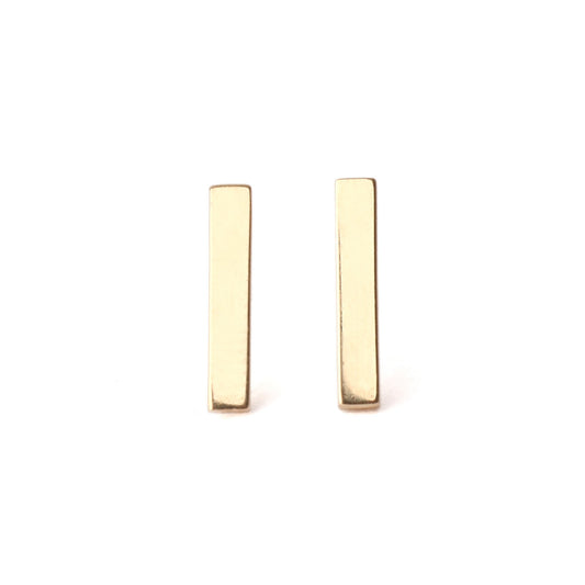A pair of solid yellow gold bar stud earrings set on a white background for the shopper to view, both facing forwards.