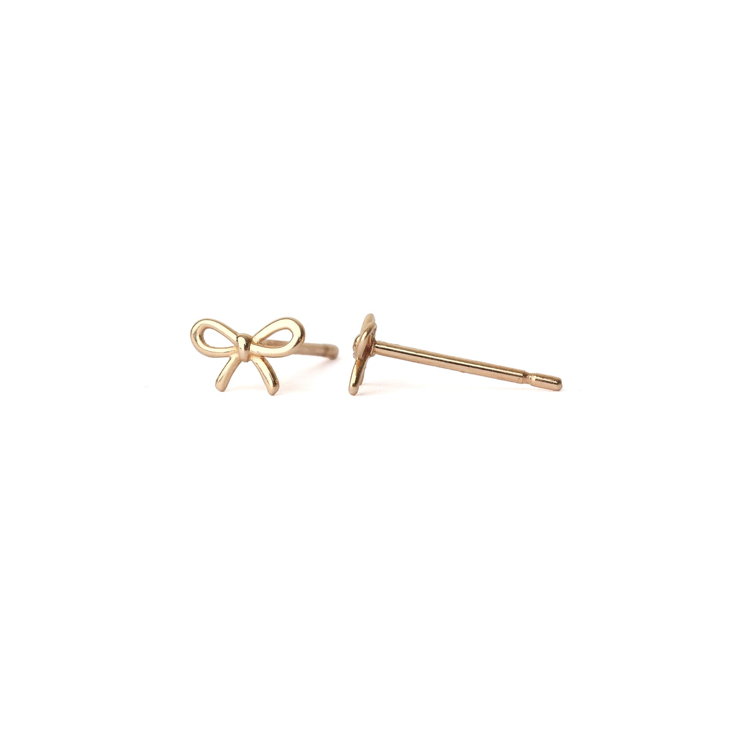 A pair of solid yellow gold bow studs, one facing forward the other sideways, set on a white background for the shopper to view.