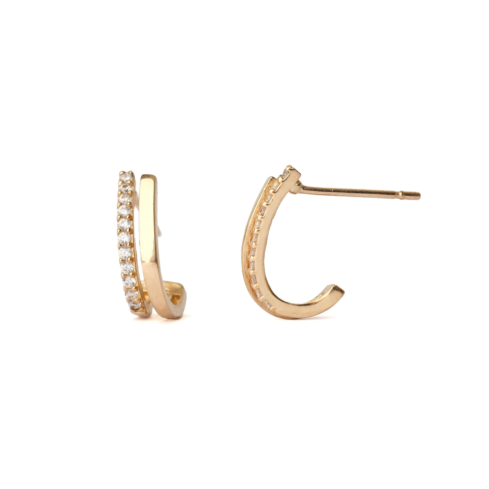 A pair of solid yellow gold half hoop earrings set with cubic zirconia along one edge. One earring is facing frontwards the other side on and both are on a white background for the shopper to view.