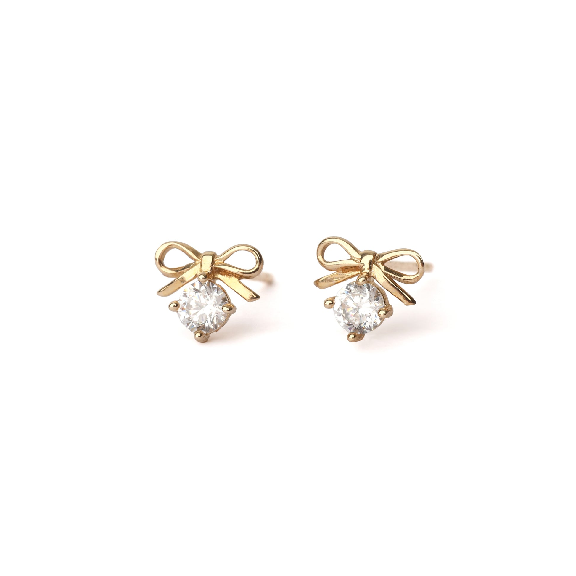 A pair of solid yellow gold bow earrings with a moissanite gemstone under the bow. Both earrings face forwards and are set on a white background for the shopper to view.