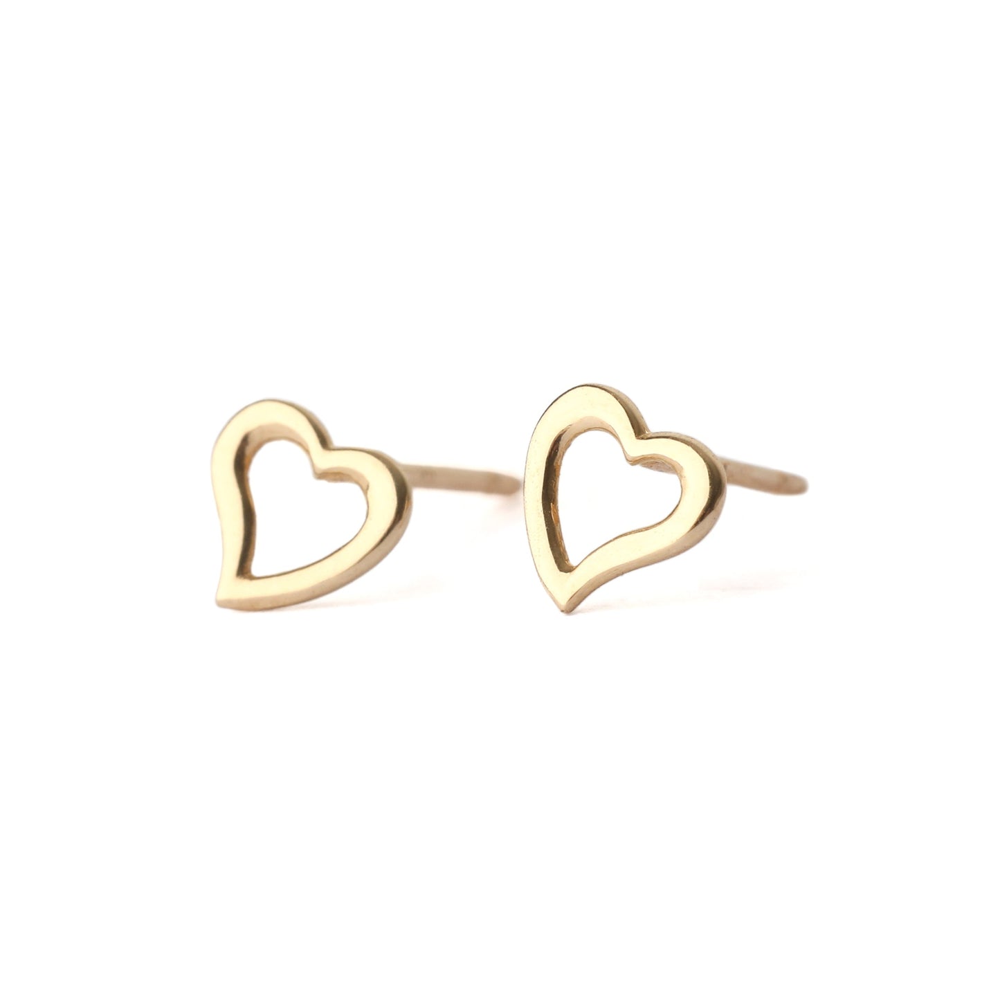 A pair of solid yellow gold heart shape earrings with an open centre, displayed on a white background, one facing forward and one side on for the shopper to see.