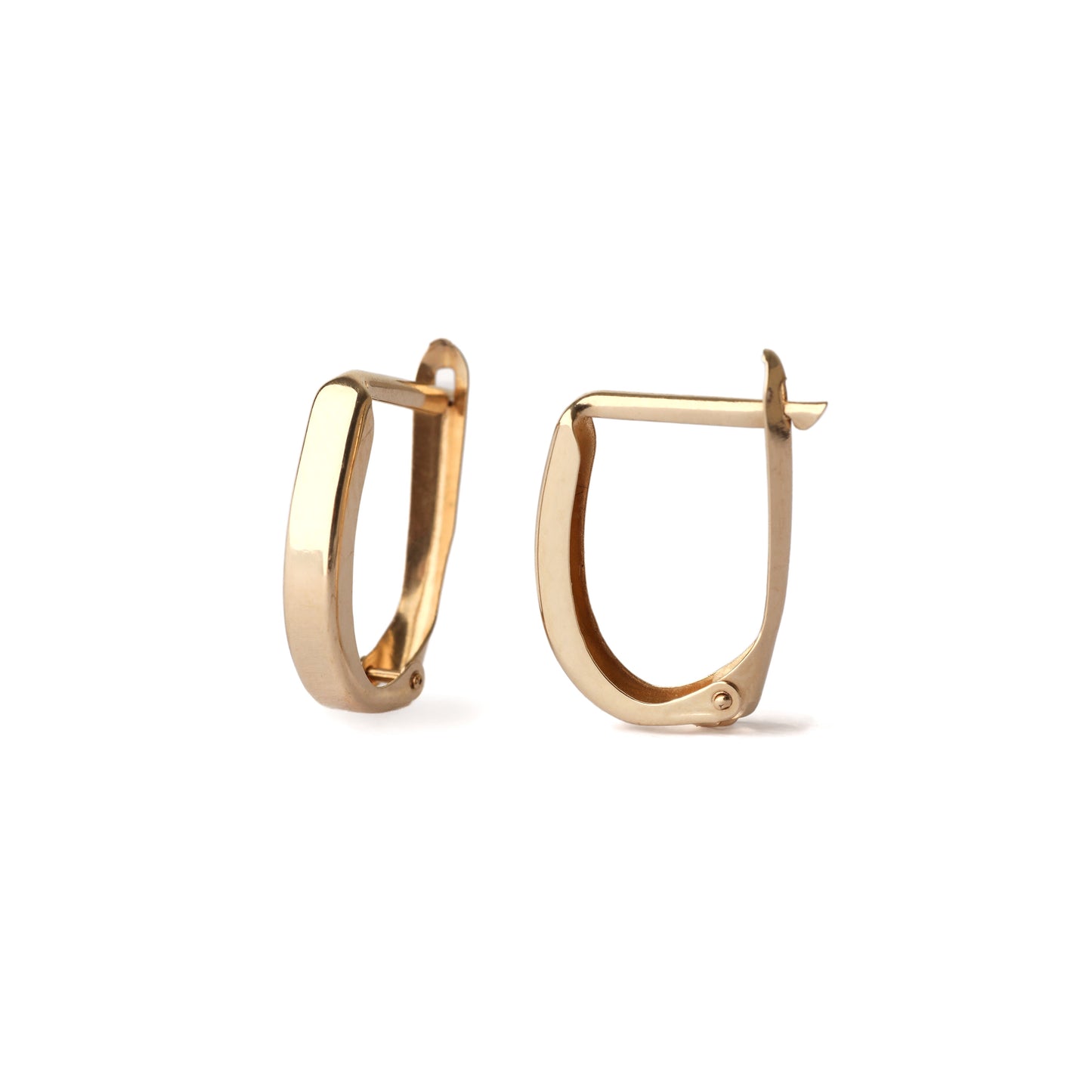 A pair of solid yellow gold huggie hoop earrings in a classic style. One is facing forwards and the other sideways and both are displayed on a white background for the shopper to view.