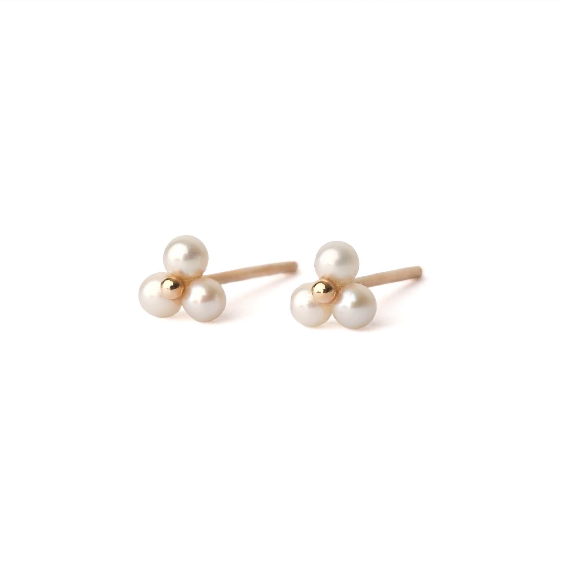 A pair of solid yellow gold freshwater pearl stud earrings. Each earring has three tiny pearls surrounding a small gold centre like a flower. The earrings are displayed on a white background for the shopper to view, both facing forward.