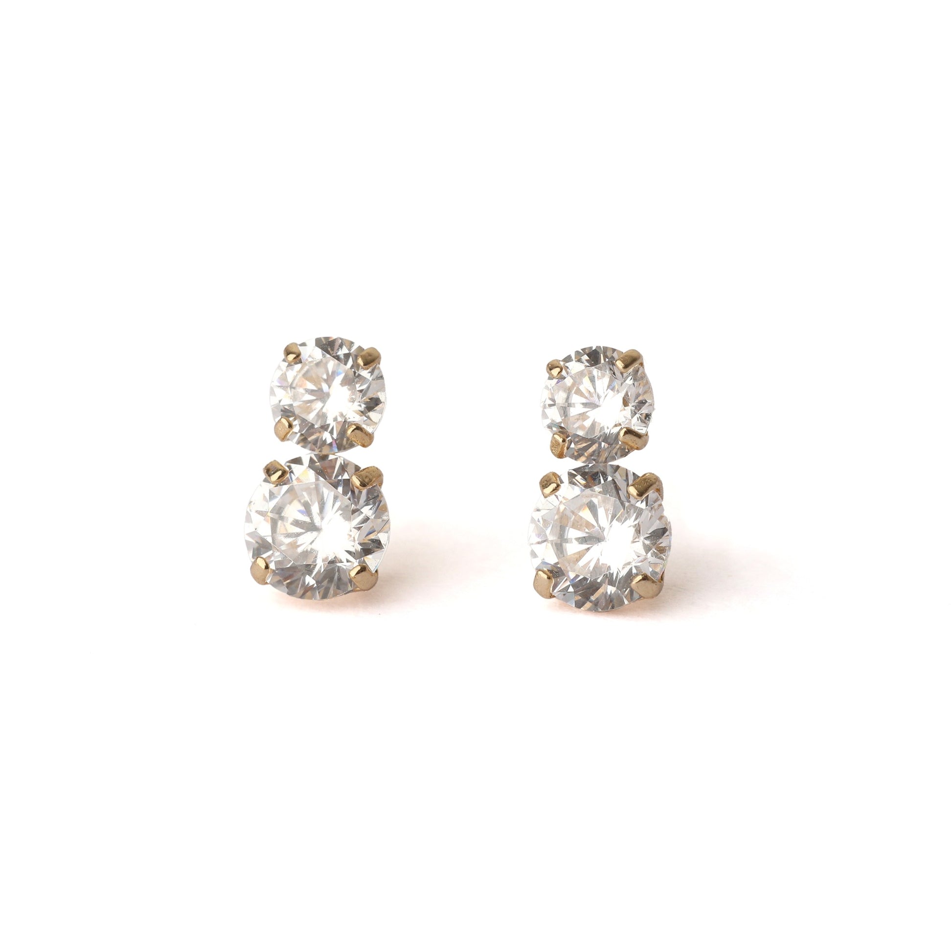 A pair of women's solid yellow gold stud earrings, each with two cubic zirconia gemstones. The top gemstone is slightly smaller the the one below. Both earrings face forward and are displayed on a white background.