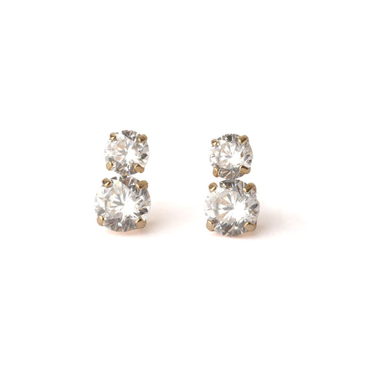 A pair of women's solid yellow gold stud earrings, each with two cubic zirconia gemstones. The top gemstone is slightly smaller the the one below. Both earrings face forward and are displayed on a white background.