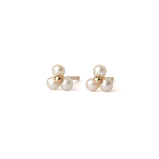 A pair of solid yellow gold freshwater pearl stud earrings. Each earring has three tiny pearls surrounding a small gold centre like a flower. The earrings are displayed on a white background for the shopper to view, both facing forward.