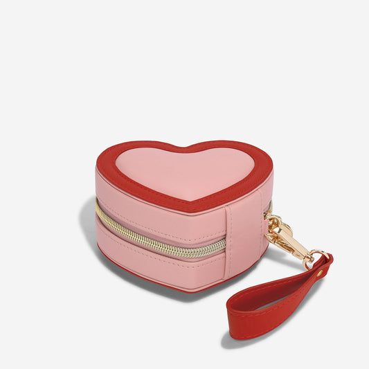 Heart-shaped pink and red Stackers travel jewellery case on a white background.