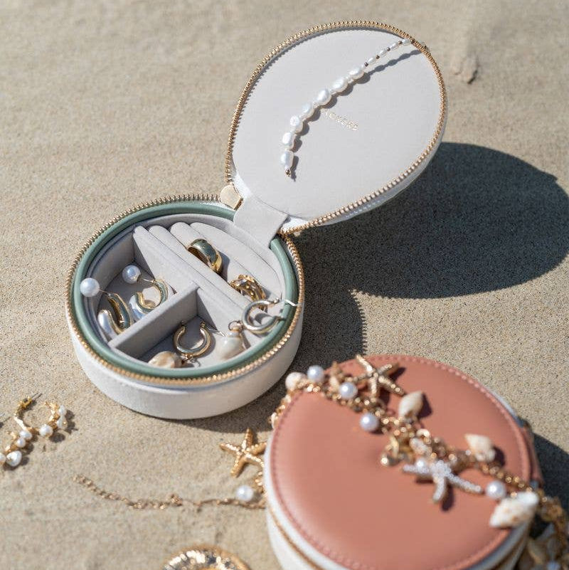 Stackers round wave jewellery box case with accessories on a sandy surface