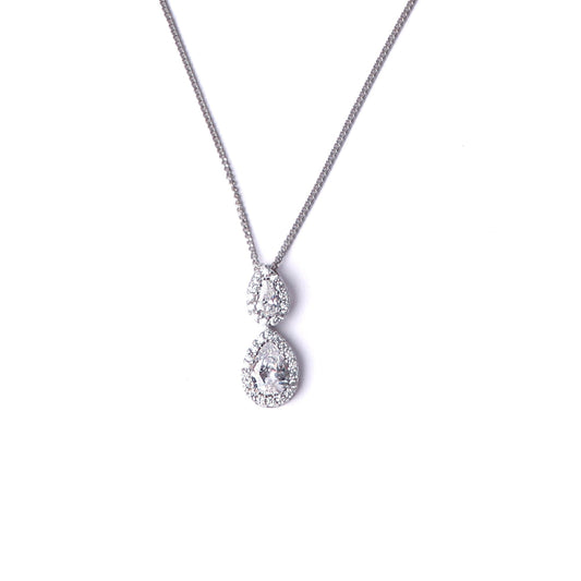 Women's sterling silver pendant with two pear shaped cubic zirconia gemstones surrounded by smaller cubic zirconia gemstones handing on a silver chain, set on a white background.