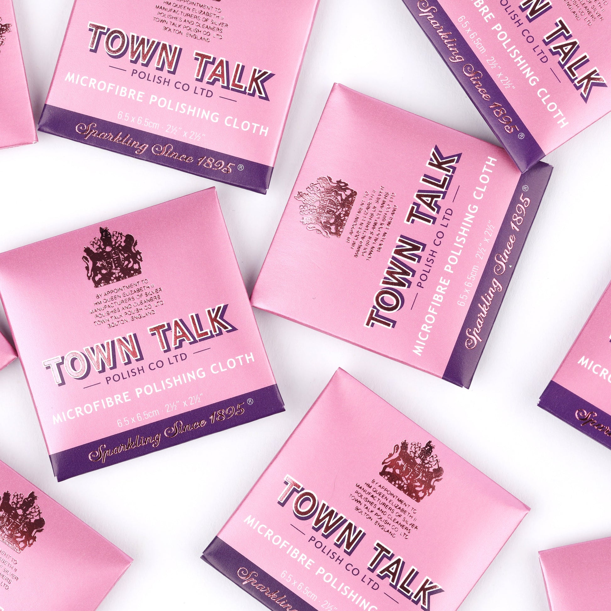 Town Talk universal microfibre polishing cloths for jewellery in pink boxes scattered on a white background
