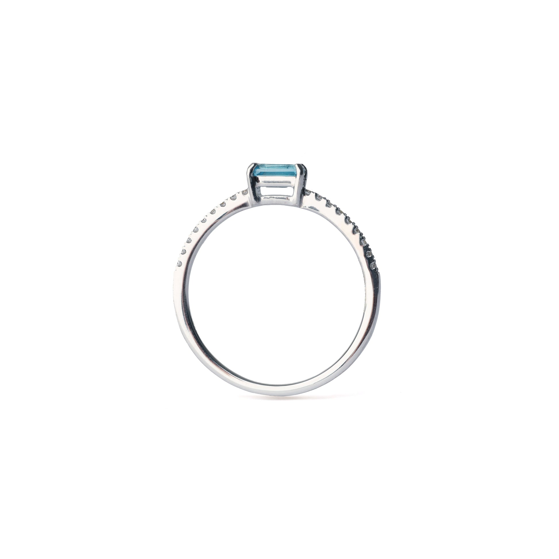 Women's white gold ring set with diamonds and blue topaz on a white background