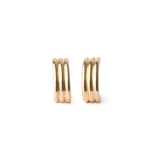 A pair of women's solid gold half hoop stud earrings on a white background