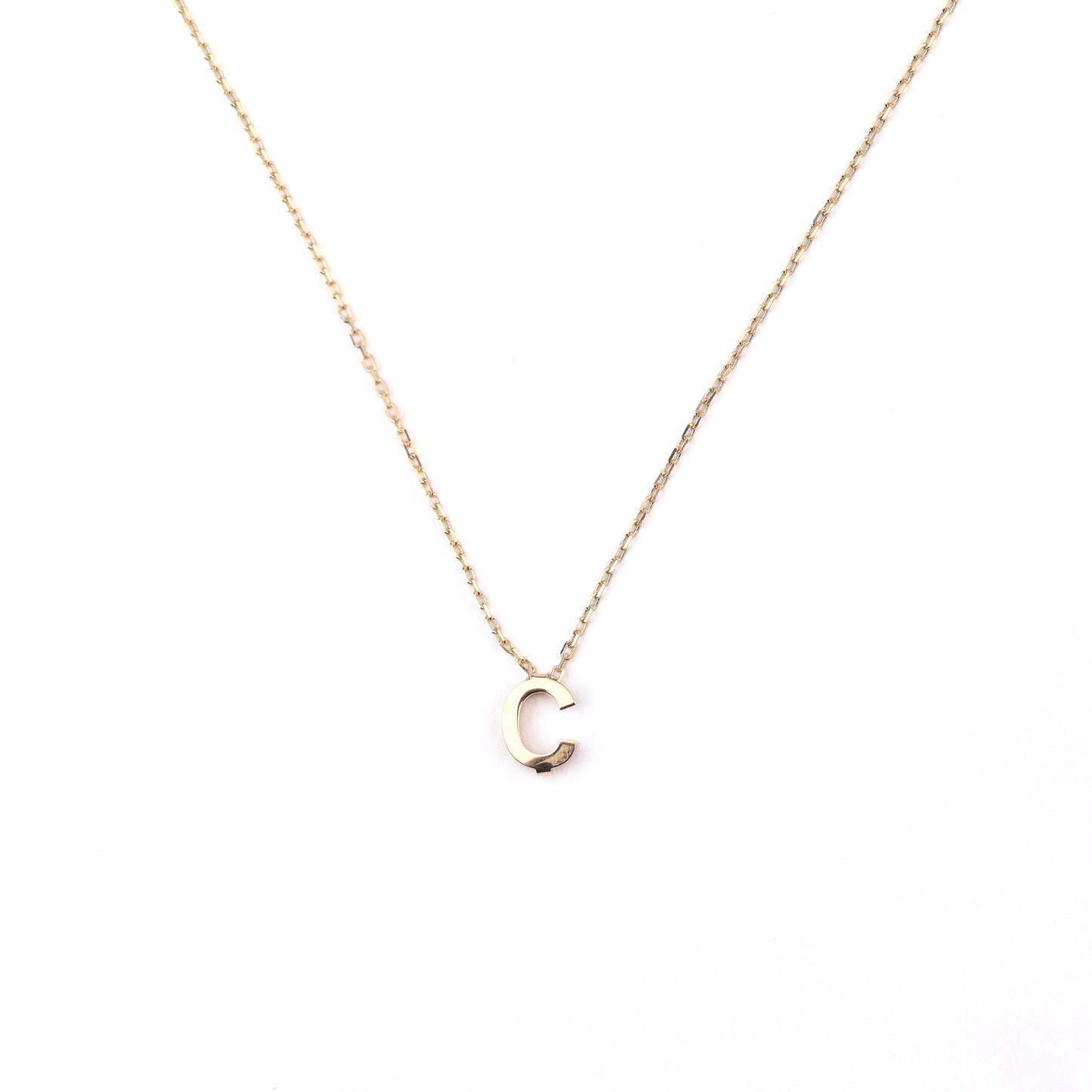women's solid gold necklace with a 'C' letter pendant on a white background