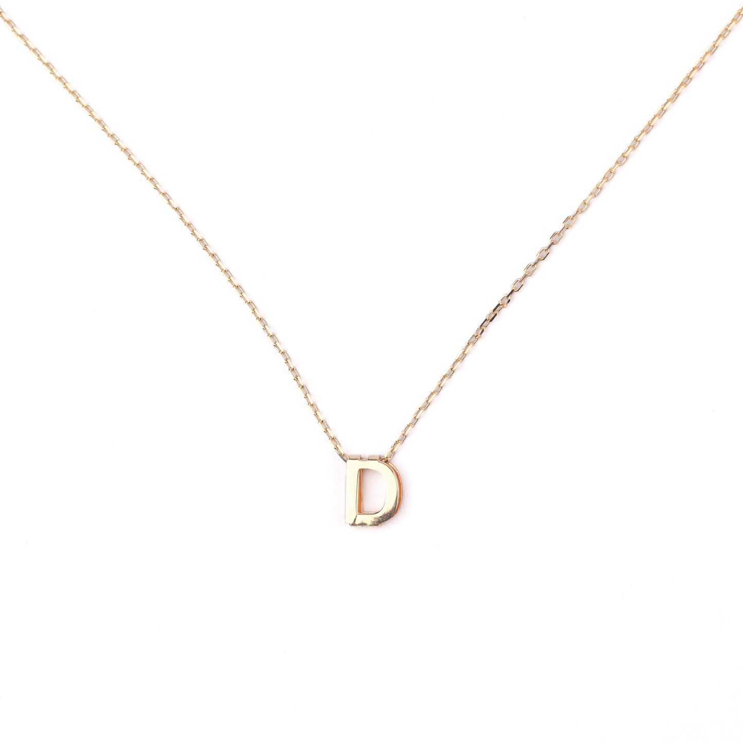 women's solid gold necklace with a 'D' pendant on a white background