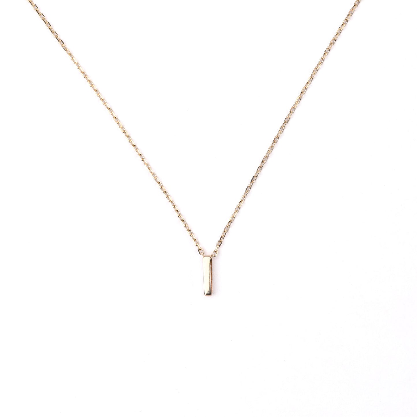women's solid gold necklace with an 'I' pendant on a white background
