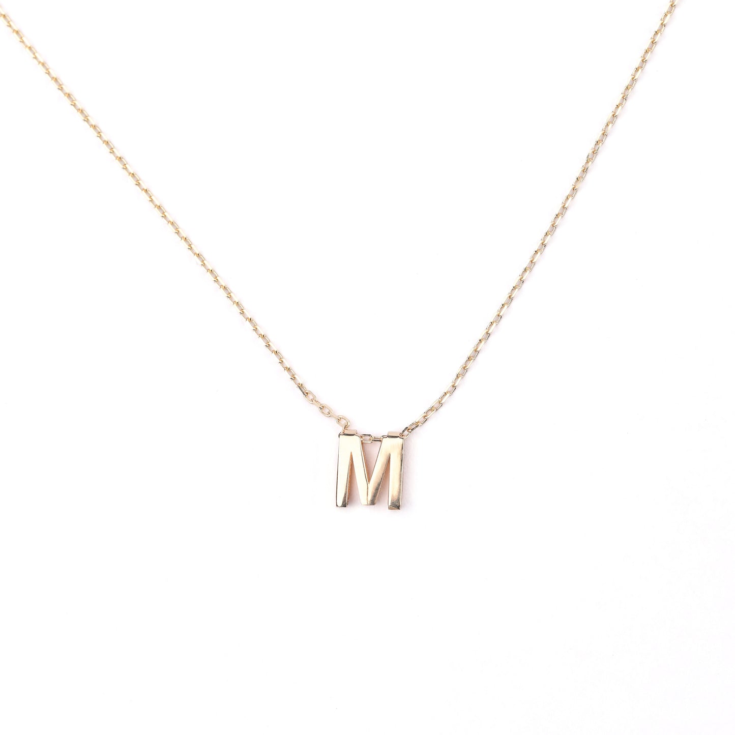 women's solid gold necklace with a 'M' pendant on a white background
